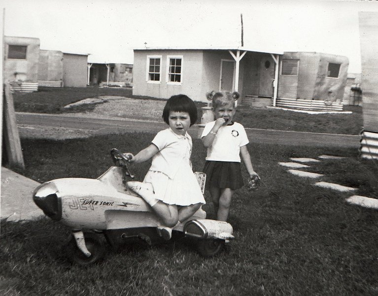 Dreux-1A.jpg - My sister, Susie, and her French friend Marie-Fredo. Taken by our trailer. Note that the trailers across the street were not occupied as evidenced by the lack of gas bottles. - Doug