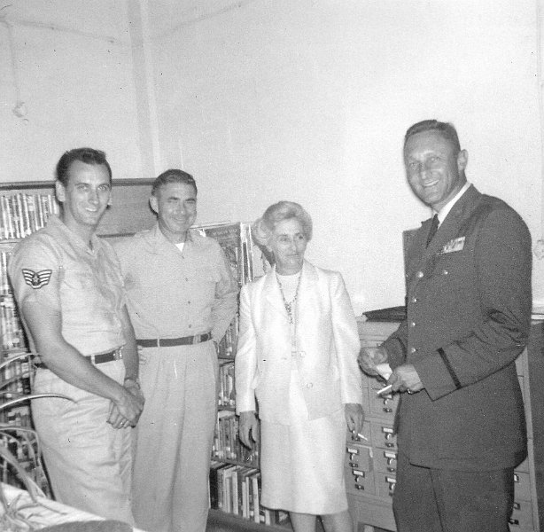 LibraryW.jpg - Library - Second from the left is my father (Lt Col Don Donnell); third from the left is Mme Hoquetis, the base librarian, then Nathan Stern, the base commander. So far we have not identified the Staff Sargeant.