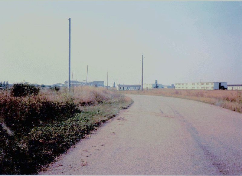 Dreux AB Entrance Road to Guard Shack Aug 1987.JPG