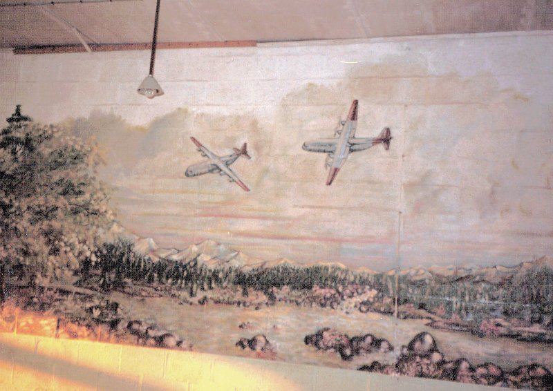 Dreux AB Mess Hall Mural wall across runway at 24 end Aug 1987.JPG