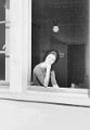 French Library worker In Library window Dreux AB 1960