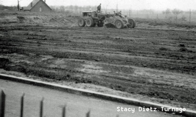 DreuxJohnacrossstreet_edited-1.jpg - Dad (on roadgrader) Clearing Land Across from Our House for Community Events